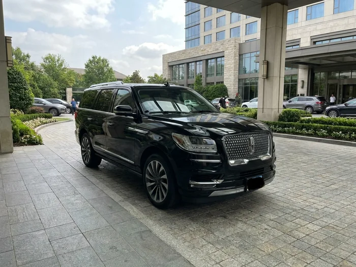 Black Lincoln Navigator waiting at a Vancouver hotel entrance
